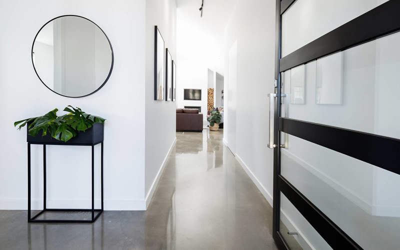 a hallway in a Swansea residence which has concrete polished flooring